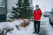 solo travel Asian female tourist walking on winter street at Grundarfjordur town