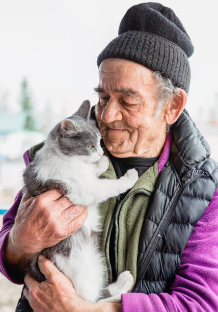 istock Old Russian man holding his cat and smiling 2150076459