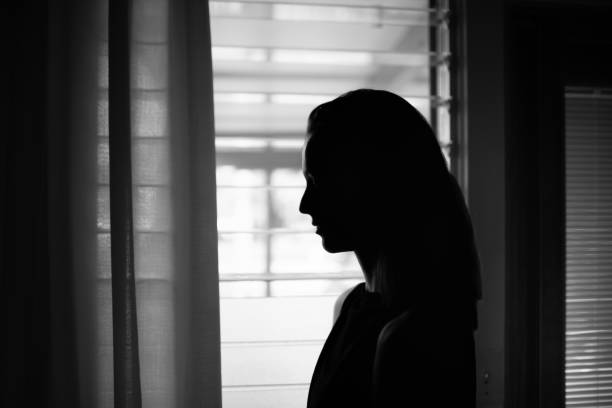 istock Sad depressed woman feeling lonely at home next to window 2150076581