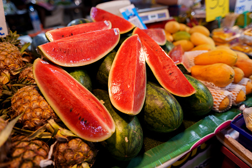Photograph of lots of watermelons for sale on a market stall