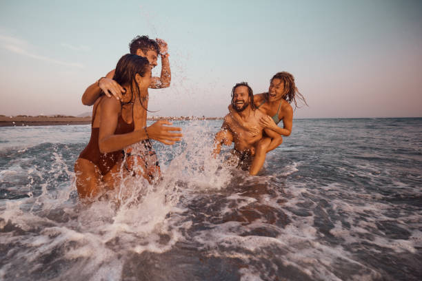istock Young cheerful couples having fun during summer vacation in sea. 2150078644