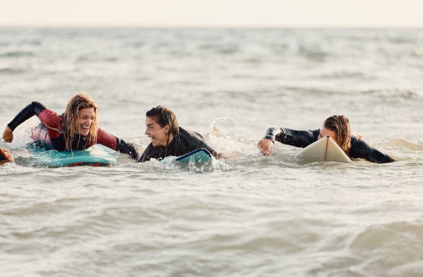 istock Cheerful surfers having fun in summer day at sea. 2150078749