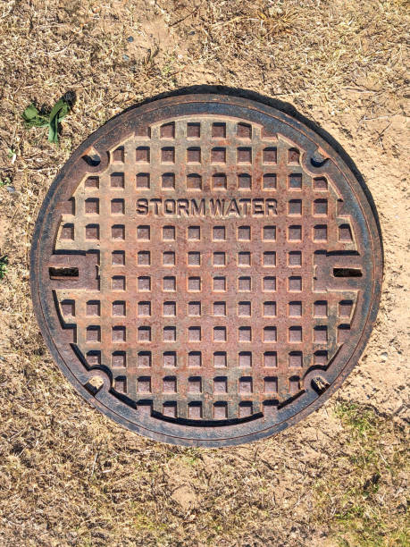 istock A manhole cover for stormwater pipes embedded in drought stricken dry turf 2150078837