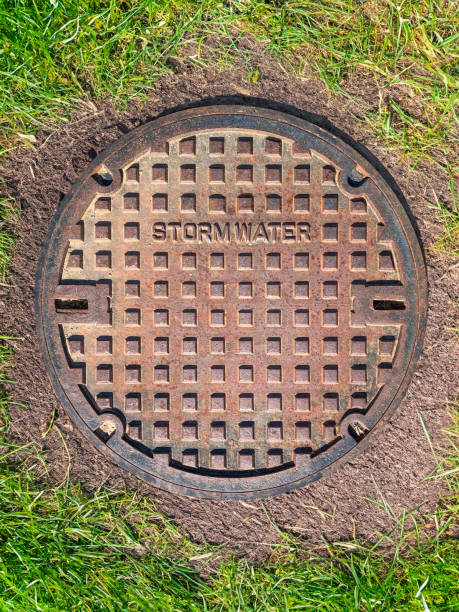 istock A manhole cover for stormwater pipes embedded in green turf 2150078849