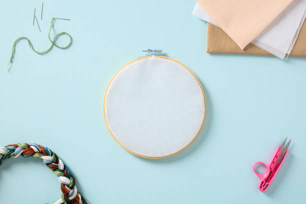 istock Cross stitch embroidery accessories on blue background. Flat lay, top view. 2150078994