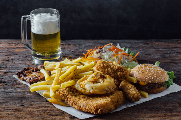 istock Junk food that includes french fries, fried chicken with draft beer 2150079239
