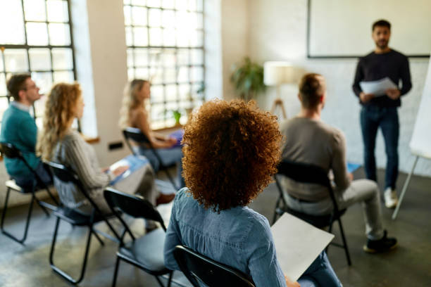 istock Back view of freelancers having a seminar in board room. 2150080284