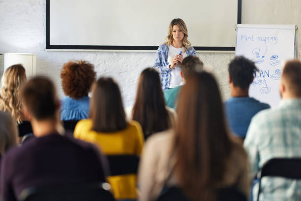 istock Female public speaker talking on a seminar in board room. 2150080298