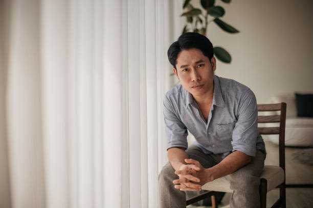 Portrait of a mid-adult man looking seriously at the camera.