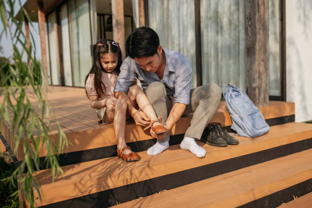 istock Father preparing daughter for school 2150080824