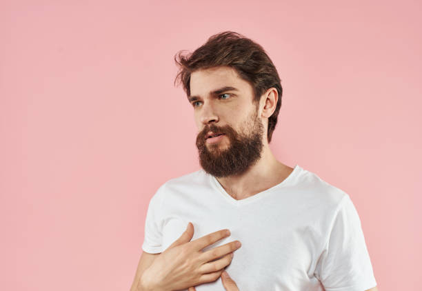 istock A man with a beard and mustache on a pink background gestures with his hands 2150080852