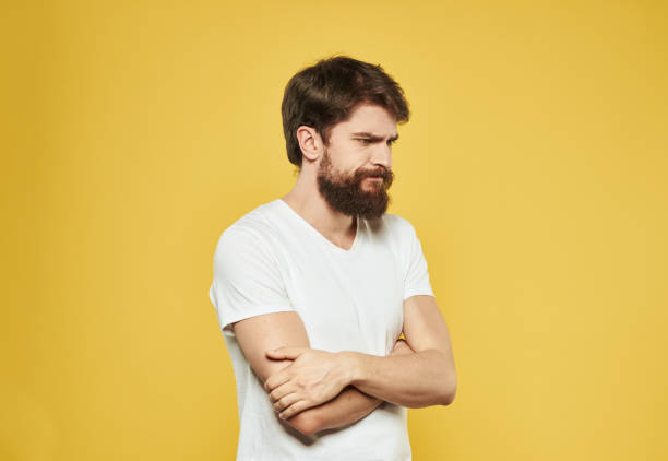 istock Emotional guy gesturing with his hands on a yellow background model side view 2150081099