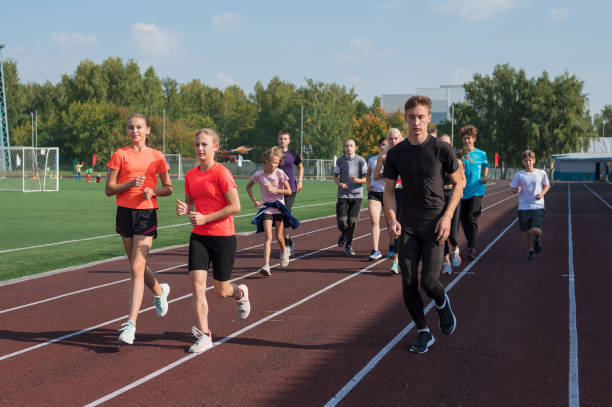 istock Group of young athletes training at the stadium 2150081220