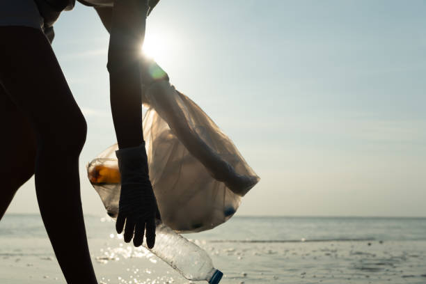 istock Save water. Volunteer pick up trash garbage at the beach and plastic bottles are difficult decompose prevent harm aquatic life. Earth, Environment, Greening planet, reduce global warming, Save world 2150081412