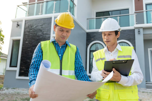 istock inspector or engineer is inspecting construction and quality assurance new house using a blue print. Engineer or architects or contactor work to build the house before handing it over to the homeowner 2150081456