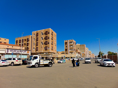 An Arabian view of the city of Taif that combines the brown buildings and sanda with the deep blue sky in the sunny day.