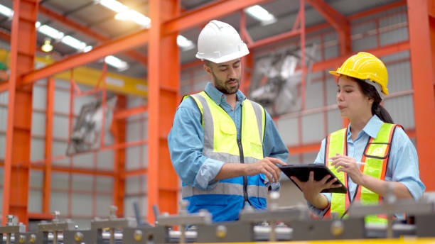 istock Engineers examining a machines in factory. 2150081813