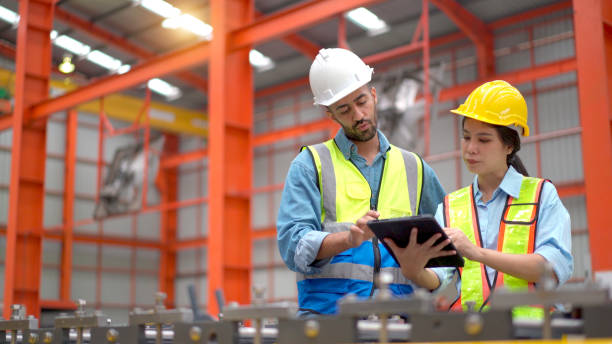 istock Engineers examining a machines in factory. 2150081815