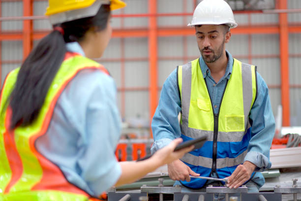 istock Engineers examining a machines in factory. 2150081819