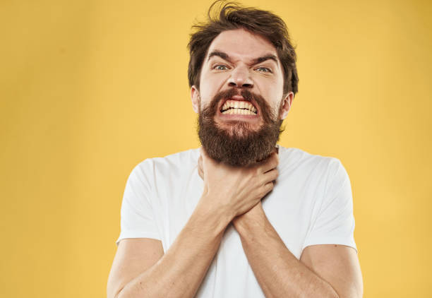 istock An angry man on a yellow background with an indignant look is gesturing with his hands 2150081926