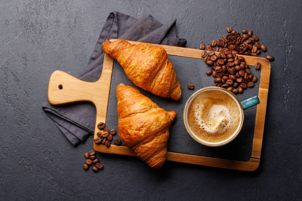 istock Cappuccino coffee and fresh croissants 2150081968