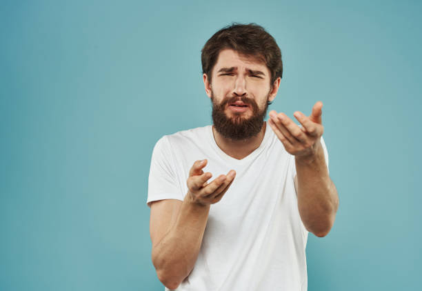 istock Man holds hands near face cropped look puzzled look 2150082010
