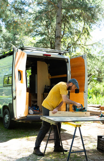istock Man working with wood to camper a van 2150083312