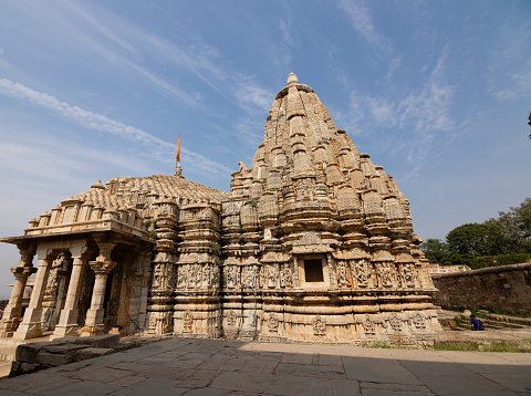 Chittorgarh, Rajasthan, India - November 4th 2023: The wide angle view of temple in Chittorgarh fort on cloudy blue sky