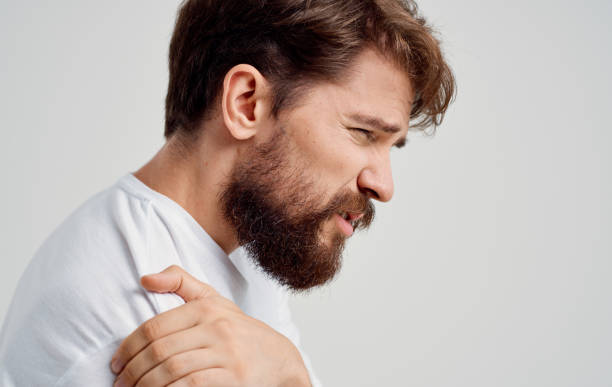istock bearded man touching shoulder with hand pain dislocation medical intervention 2150083411