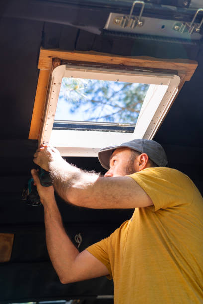 istock Caucasian man fixing a skylight of a motorhome 2150083431