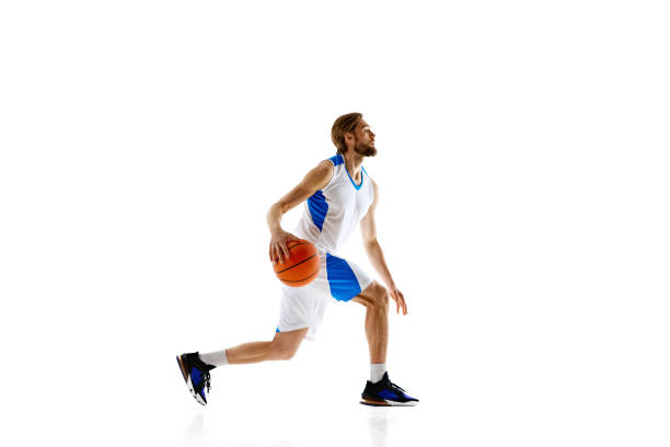 istock Competitive athlete practicing, basketball player in uniform in motion with ball isolated on white background. Concentration 2150083967