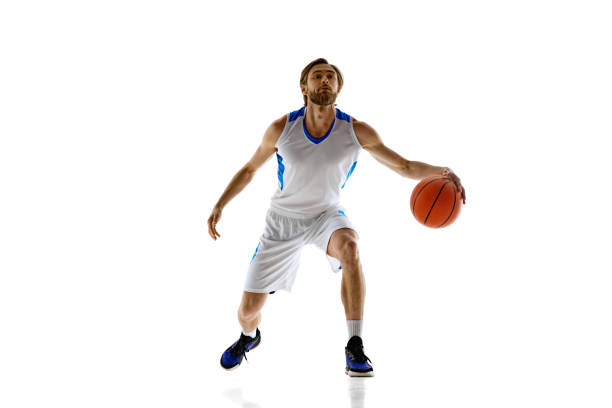 Competitive young man practicing. basketball player dribbling ball, training isolated on white background. Concept of sport, competition, active and healthy lifestyle, game