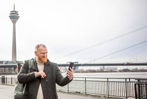 istock Redhead tourist man interacting with a smartphone 2150086008