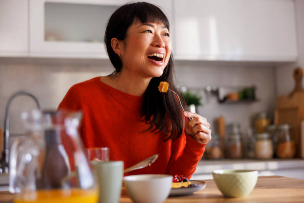 istock Woman having waffles for breakfast 2150086207