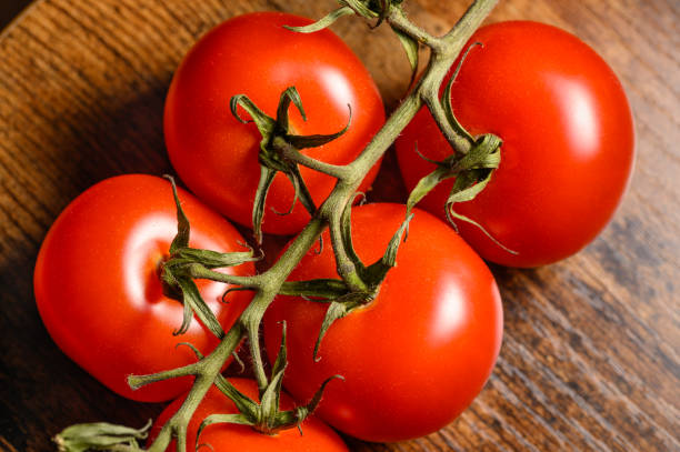 istock Ripe tomatoes twig in macro closeup 2150086957