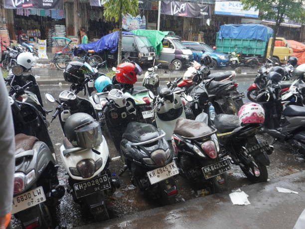 istock motorbikes parked in open areas when it rains 2150087017