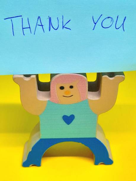Teddy Bear Holding Smart Phone Reading “Thank You”. Plenty of copy space on the white background.