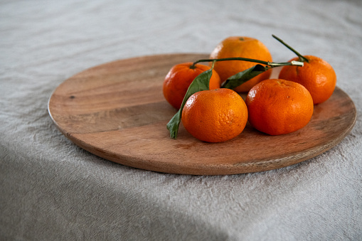 tangerine on wooden tray on the table