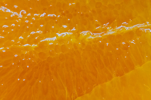 Orange slice close up food textured background