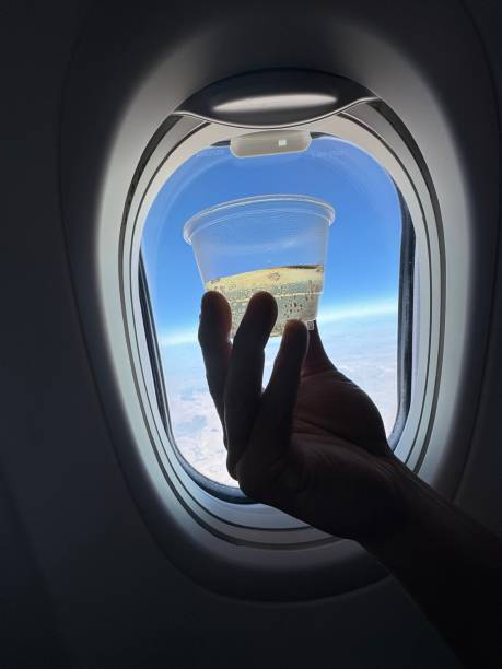 istock Savoring a drink on an airplane 2150088684