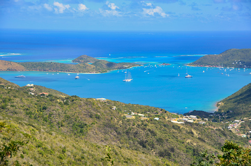View of a Caribbean bay in the British Virgin Islands with boats surrounded by islands on a sunny day