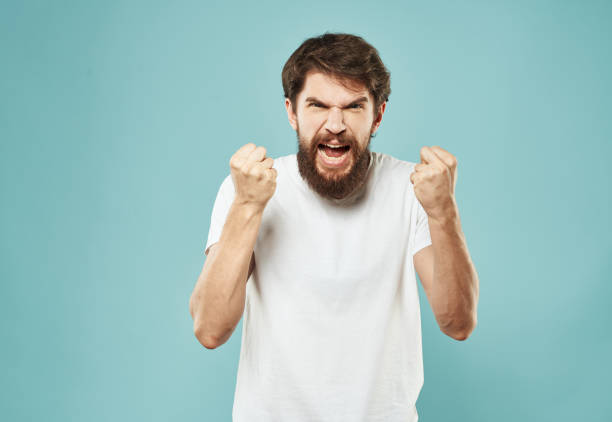 istock Aggressive man emotions and stress irritability blue background 2150089315