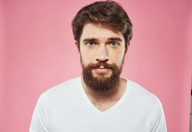 istock Man with a beard on a pink background sad face emotions model 2150090024