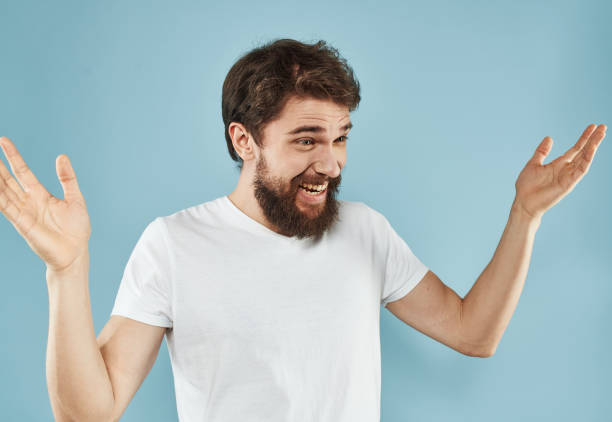 istock man with raised up arms gesturing on a blue background in a white t-shirt 2150090197