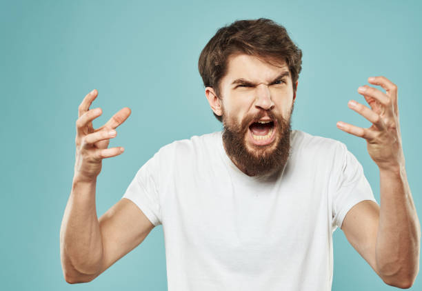 istock emotional man with beard on blue background gesturing with hands cropped view Copy Space 2150090394