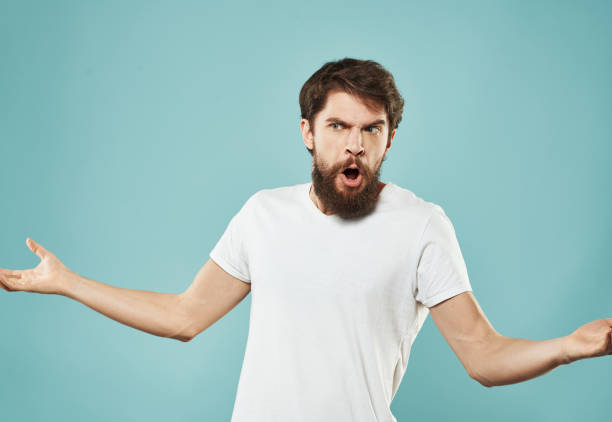 istock Angry guy gesturing with his hands on a blue background cropped with Copy Space 2150090455