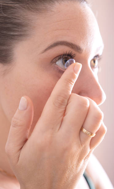 istock Woman Inserting Soft Contact Lens in Eye, Corrective Vision Care 2150090483