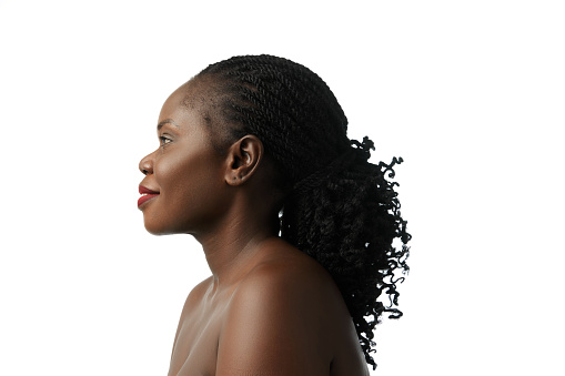 Profile portrait of elegant African woman with curly dark hair, well-kept skin posing isolated on white background. Face lifting. Concept of natural beauty, skin and body care, cosmetology, cosmetics