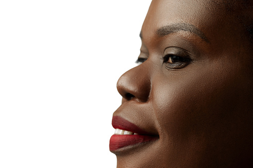Cropped close-up image of African woman with well-kept, spotless, clear face isolated on white background. Cosmetology services. Concept of natural beauty, skin and body care, cosmetology, cosmetics