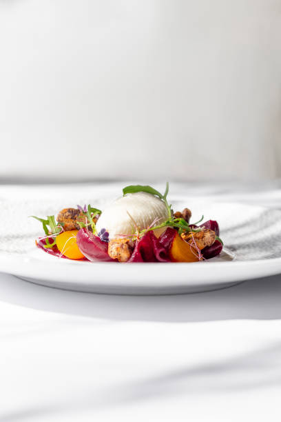Gourmet appetizer dish with beetroot vegetables and whipped goat cheese  in Maldives Fine Dining Restaurant with plate by the sea